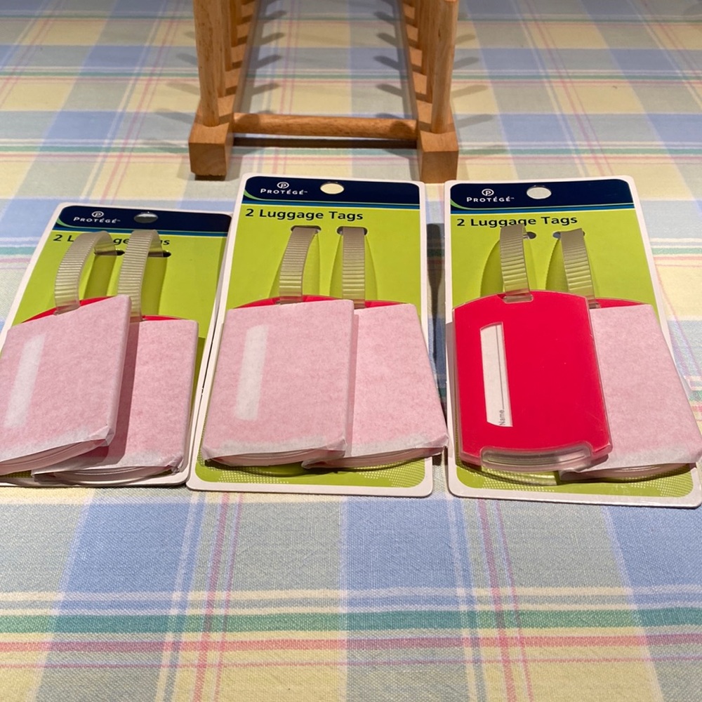 Luggage tags. Never used. 6 total. Bright red. Solid plastic secure strap